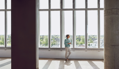 Man looking outside the big window