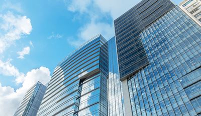A skyline view featuring sleek, modern office buildings in an urban setting