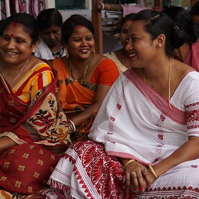 Women in saris smiling in a group
